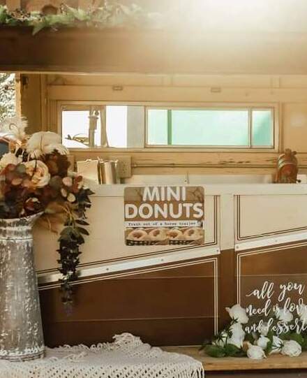 The front of the Holy Oly Os trailer with the sign 'MINI DONUTS'